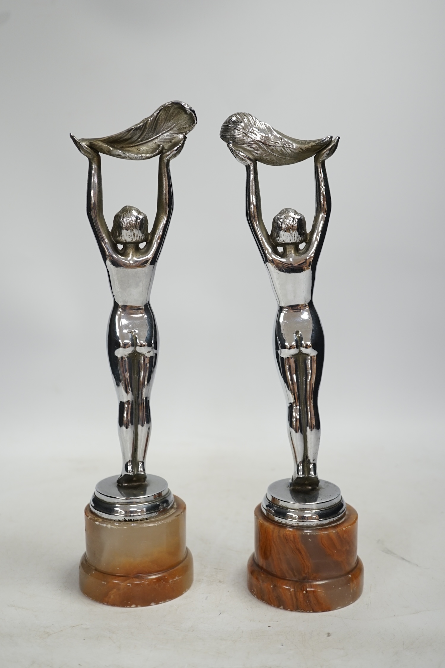 A pair of Art Deco chrome plated figures on onyx bases, 30cm. Condition - poor